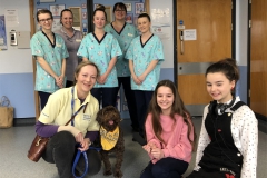 Kids presenters at Neptune Ward with staff and Rolo the Pets As Therapy dog